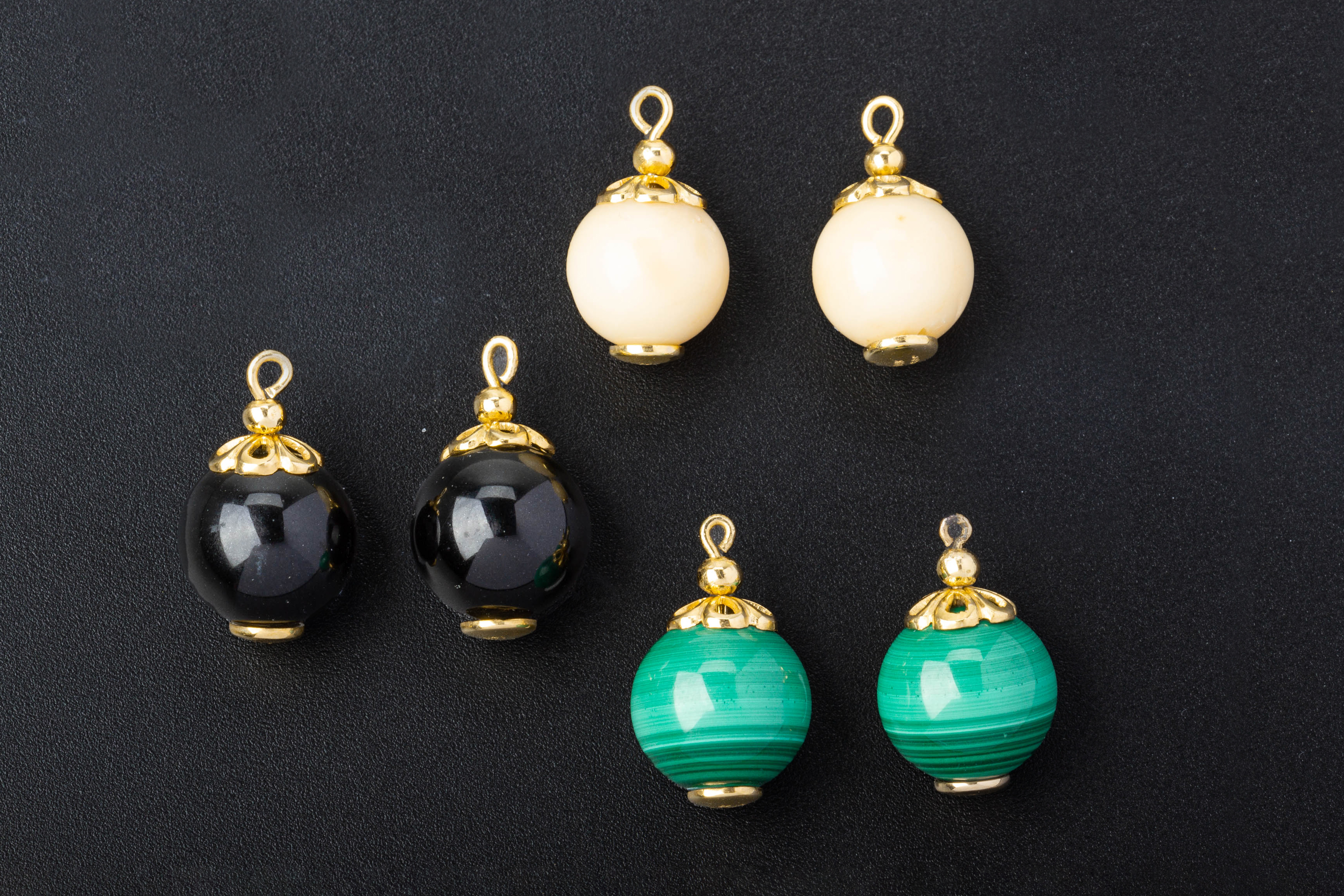 THREE PAIRS OF GOLD MOUNTED BEADS