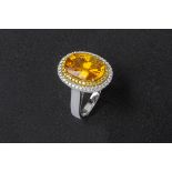 A YELLOW SAPPHIRE AND DIAMOND CLUSTER RING