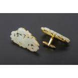 A PAIR OF CARVED JADE AND GOLD CUFFLINKS