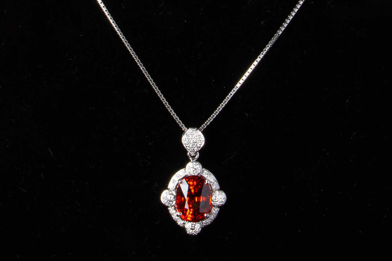 A SPESSARTINE GARNET AND DIAMOND PENDANT ON CHAIN