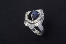 A STAR SAPPHIRE AND DIAMOND CLUSTER RING