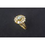 A CAT'S EYE CHRYSOBERYL AND DIAMOND CLUSTER RING