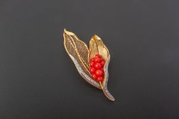 A RED COLOURED STONE AND DIAMOND BROOCH