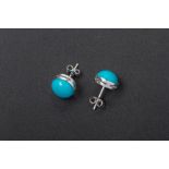 A PAIR OF WHITE GOLD AND TURQUOISE CABOCHON STUD EARRINGS