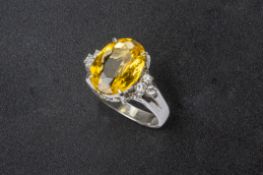 A YELLOW BERYL AND DIAMOND RING