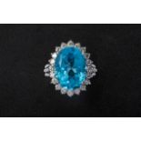 A BLUE TOPAZ AND DIAMOND CLUSTER RING