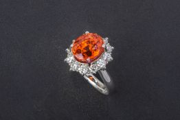 A SPESSARTINE GARNET AND DIAMOND RING