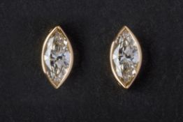 A PAIR OF MARQUISE CUT DIAMOND STUD EARRINGS