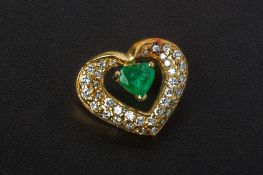 AN EMERALD AND DIAMOND HEART SHAPED PENDANT