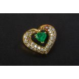 AN EMERALD AND DIAMOND HEART SHAPED PENDANT