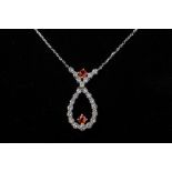 A RUBY AND DIAMOND CROSSOVER PENDANT NECKLACE