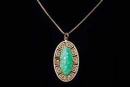 A CARVED JADE PENDANT NECKLACE