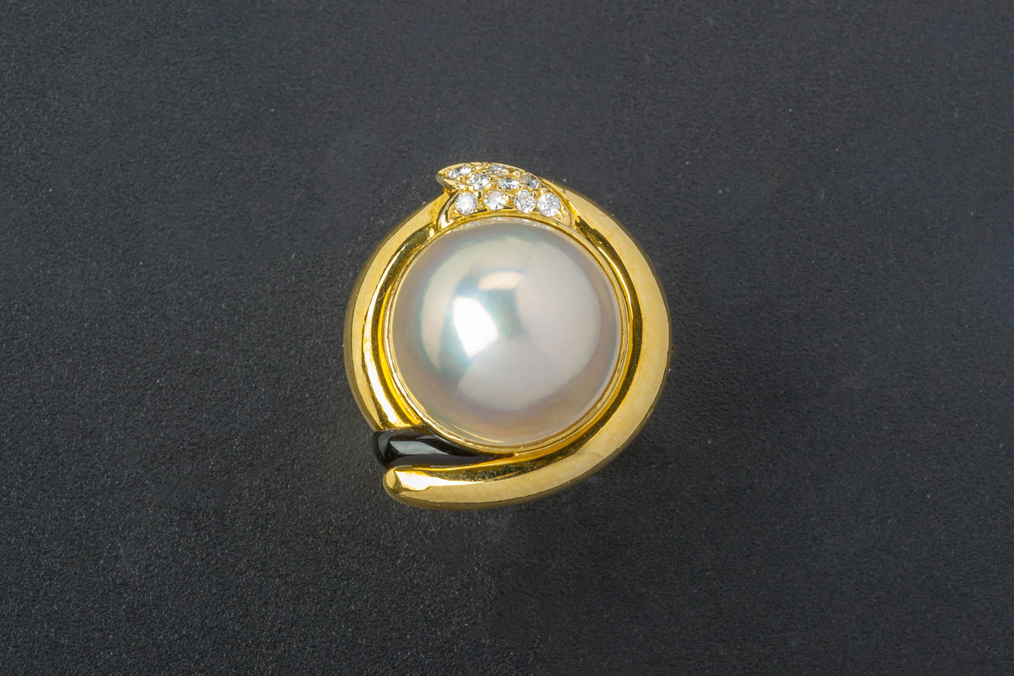 A CULTURED MABE PEARL AND DIAMOND RING