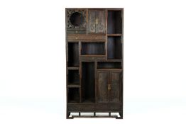 A LARGE CARVED HARDWOOD DISPLAY CABINET