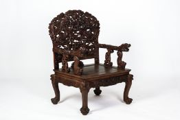 A CARVED HARDWOOD DRAGON ARMCHAIR