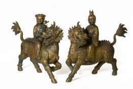 A PAIR OF METALWARE MODELS OF QILINS WITH RIDERS