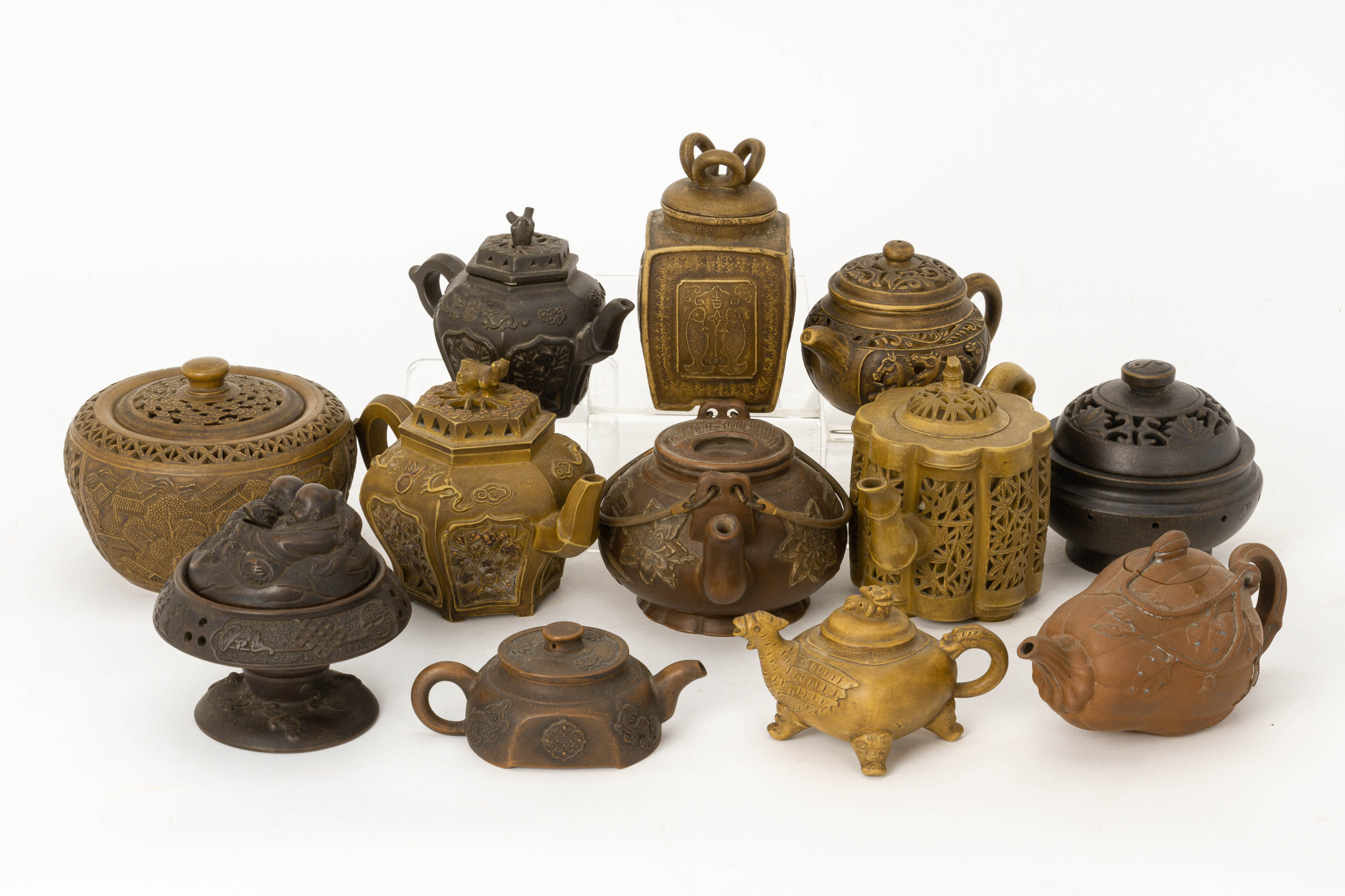 A GROUP OF TWELVE CHINESE POTTERY TEAPOTS AND COVERED BOWLS