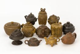 A GROUP OF TWELVE CHINESE POTTERY TEAPOTS AND COVERED BOWLS