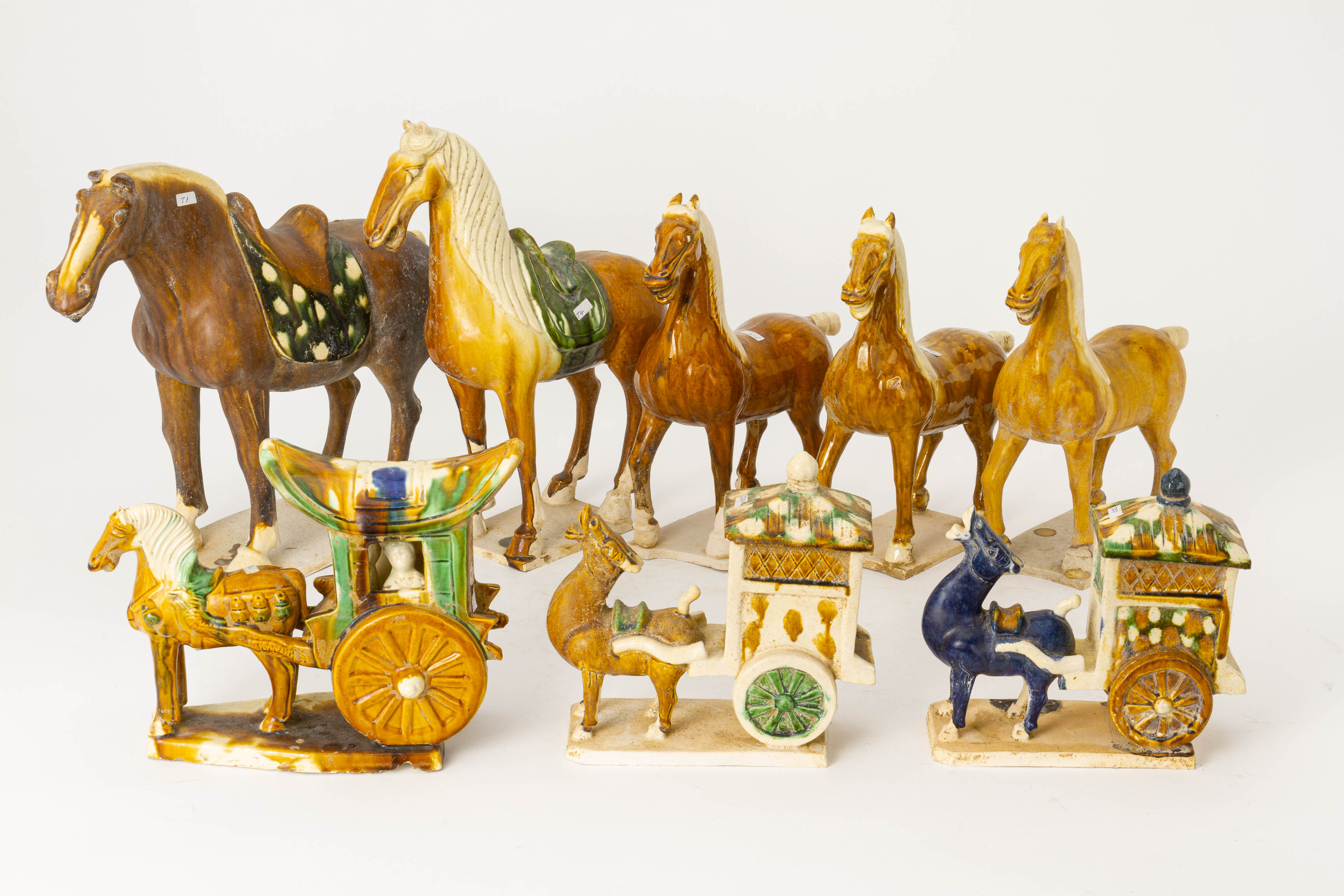 A GROUP OF TANG STYLE POTTERY HORSES AND CARRIAGES