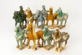 A GROUP OF NINE TANG STYLE POTTERY MODELS OF HORSES