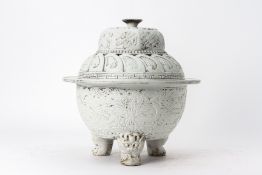 A WHITE GLAZED RELIEF MOULDED TRIPOD CENSER