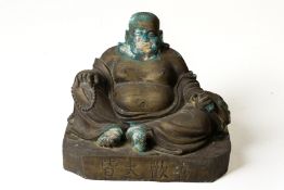 A METALWARE FIGURE OF A SEATED BUDAI