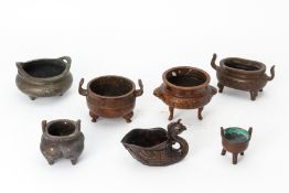 A GROUP OF SIX CAST METALWARE CENSERS AND A VESSEL