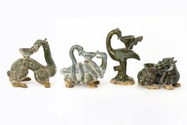 FOUR GREEN GLAZED POTTERY MYTHICAL ANIMALS