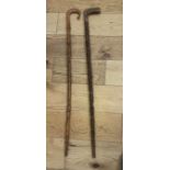 Lot of 2 Folk Art Carved Walking Sticks - both 33 1/2" long.