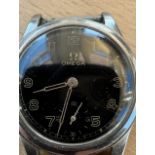 1940’s military style black dial Omega watch. movement marked 9750899 case marked 9750899 - working