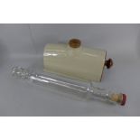 A mid 20th Century Pyrex glass rolling pin and a stoneware bed warmer