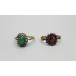 A yellow metal and garnet ring 2.0g, M and a 9ct gold and silver cluster ring, 2.8g, M/N