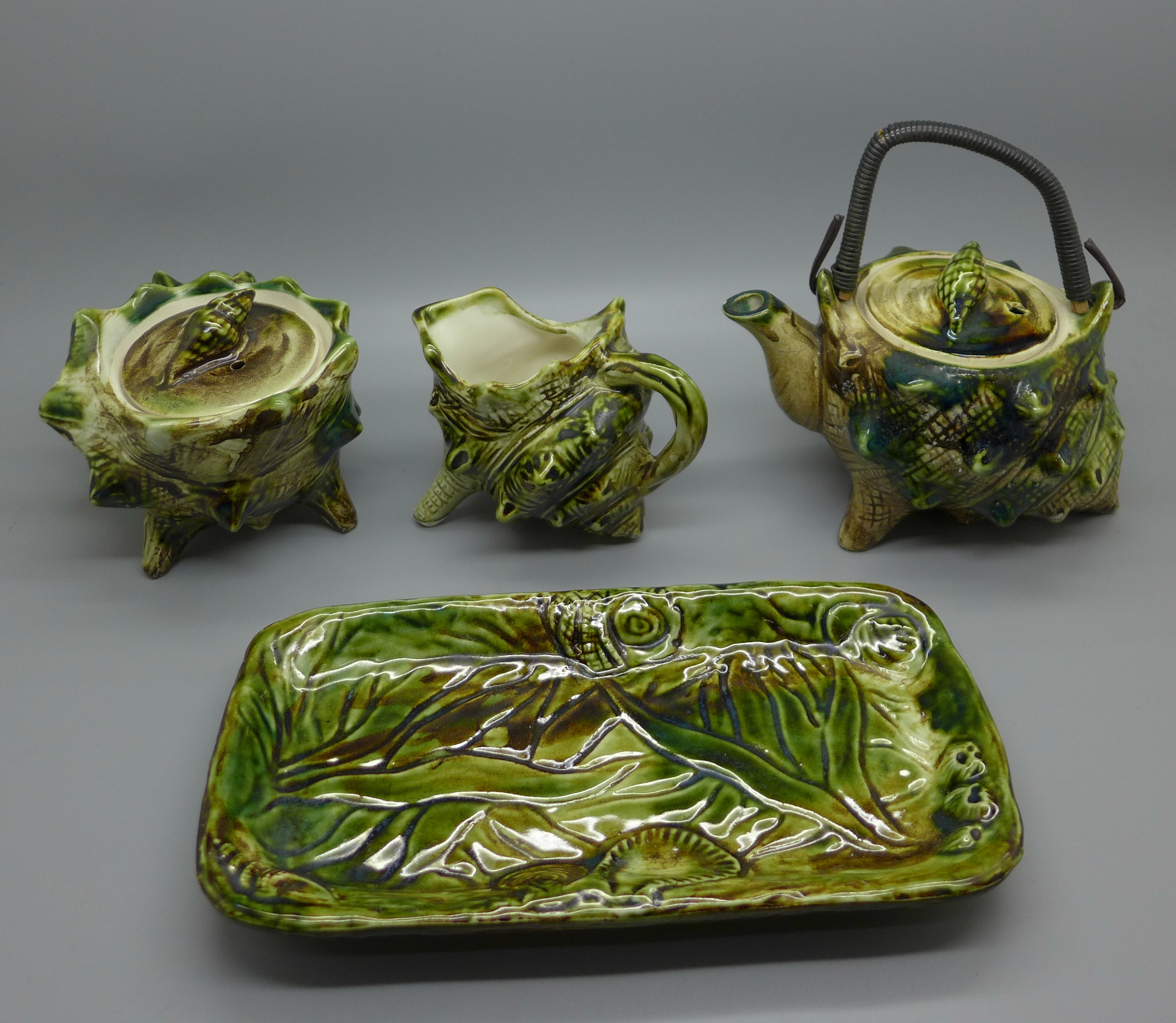 A 'Shell' majolica ceramic tea service with teapot, cream, sugar and tray