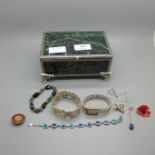 A lady's Seiko wristwatch and costume jewellery including bracelets, badges, etc., in a jewellery