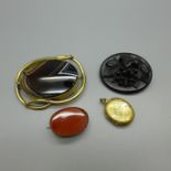 A jet brooch, two agate set brooches and a memorial locket