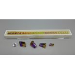 A set of twenty-five cased rainbow gemstones (garnet, citrine, peridot, amethyst, aquamarine,