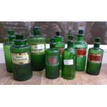 Eight green glass poison and chemist's bottles