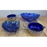 Four items of cobalt blue coloured glass, a chrome cream and sugar