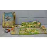 A box of German tin plate toys including helicopter and landing pad, etc.