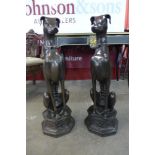 A pair of large bronze figures of seated whippets