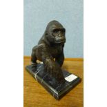 A bronze figure of a gorilla, on black marble socle