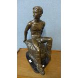 A bronze figure of a seated male nude