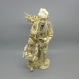 An early 20th Century carved ivory figure group, 24cm