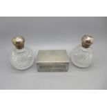 A Victorian silver topped glass dressing table pot and a pair of Victorian silver topped globular