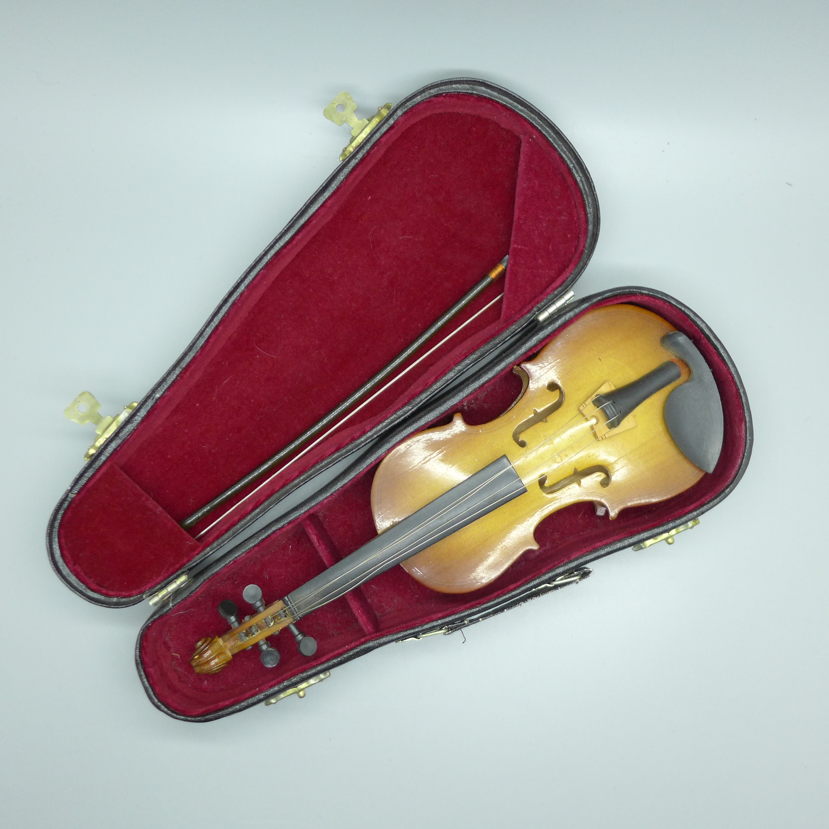A miniature model of a violin and case, 23cm
