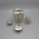 Four silver topped glass jars