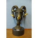 A French style bronze ram's head, on black marble socle