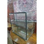 A glass two-door counter top shop cabinet