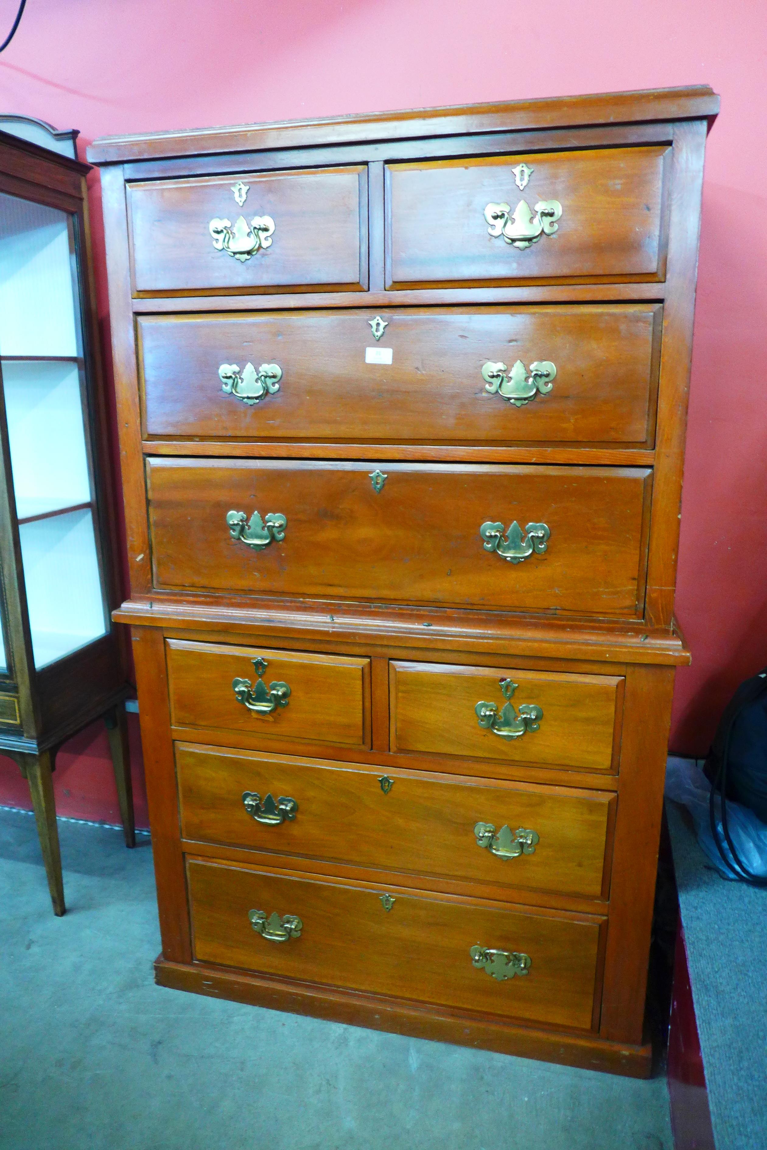 A George III style walnut chest on chest