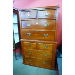 A George III style walnut chest on chest